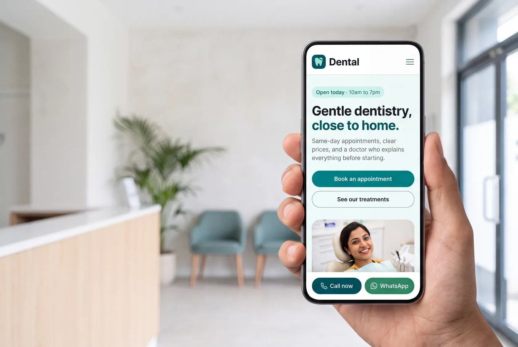 A phone held up in a clinic reception, showing a dental practice website: the clinic's name, opening hours, a headline reading Gentle dentistry close to home, a booking button, and a call and WhatsApp bar along the bottom.